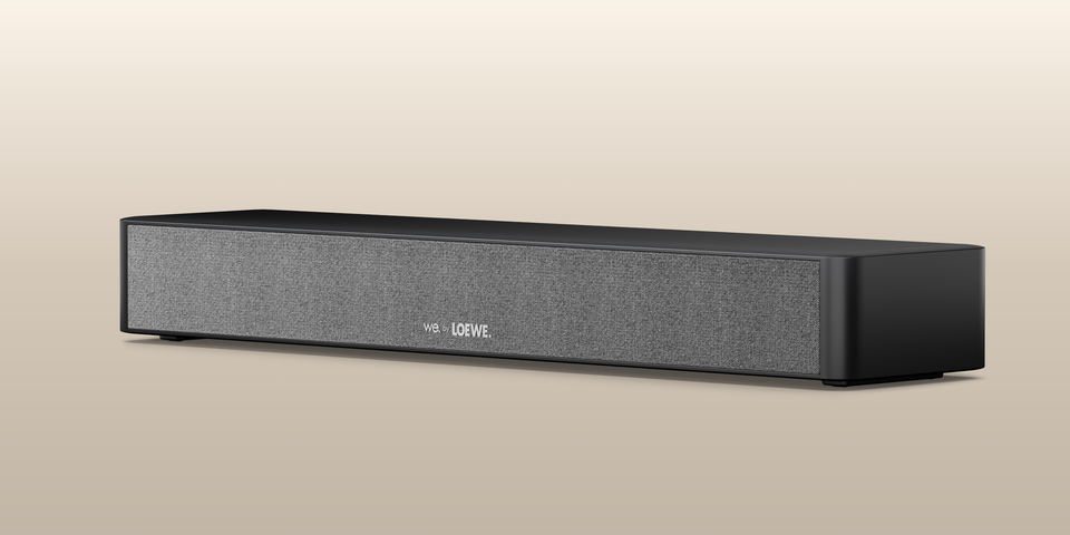 We. BOOST Center Speaker, side front view, beige background.